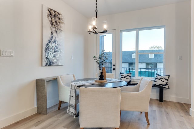 dining room featuring light hardwood / wood-style flooring and an inviting chandelier