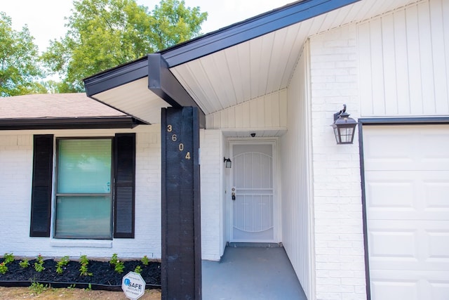 view of exterior entry with a garage