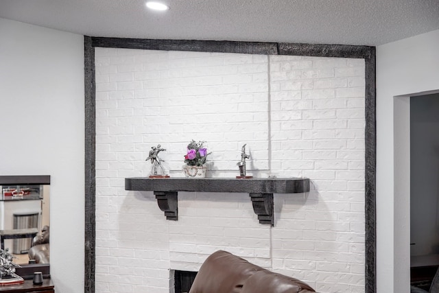 interior details with a textured ceiling and a fireplace