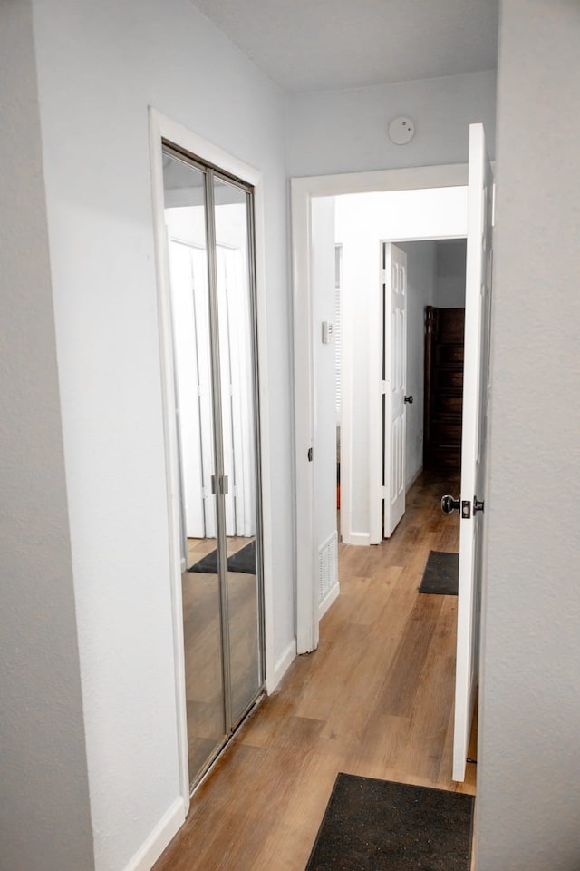 3604 Fort Hunt Dr, Arlington, TX 76016 - corridor featuring visible vents, baseboards, and light wood finished floors