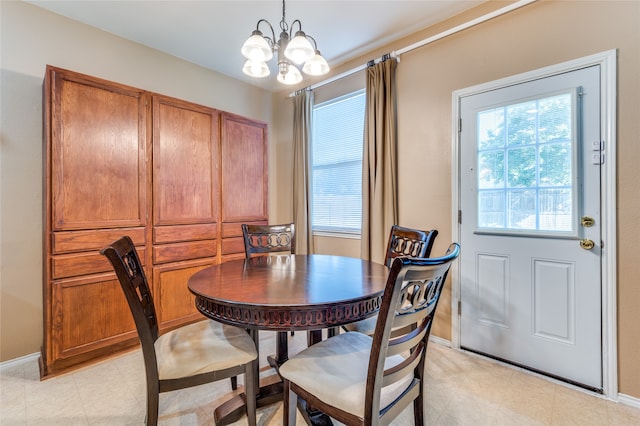 dining area featuring a notable chandelier