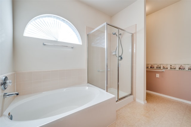 bathroom with separate shower and tub