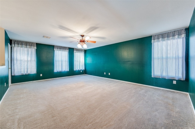 spare room with ceiling fan and carpet flooring