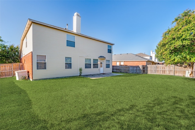 back of property featuring a lawn and a patio area