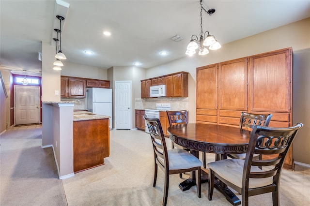 dining space with an inviting chandelier