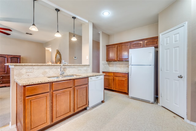 kitchen featuring ceiling fan, hanging light fixtures, sink, white appliances, and decorative backsplash