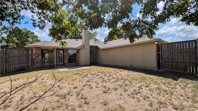 rear view of house with a lawn