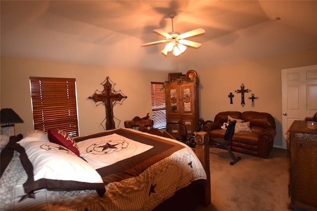 carpeted bedroom with ceiling fan and lofted ceiling