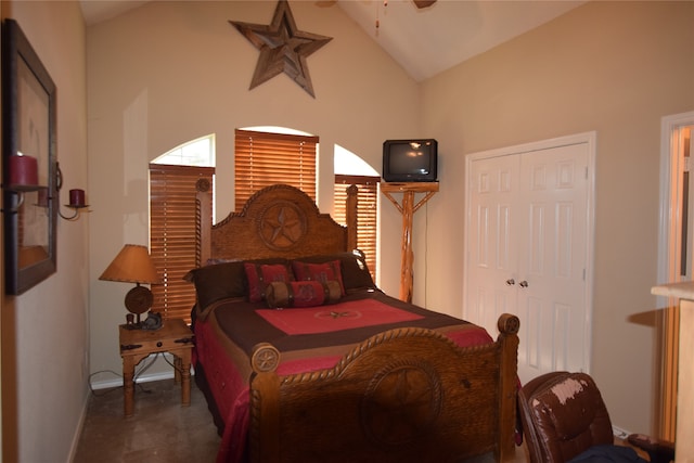 bedroom featuring high vaulted ceiling and a closet