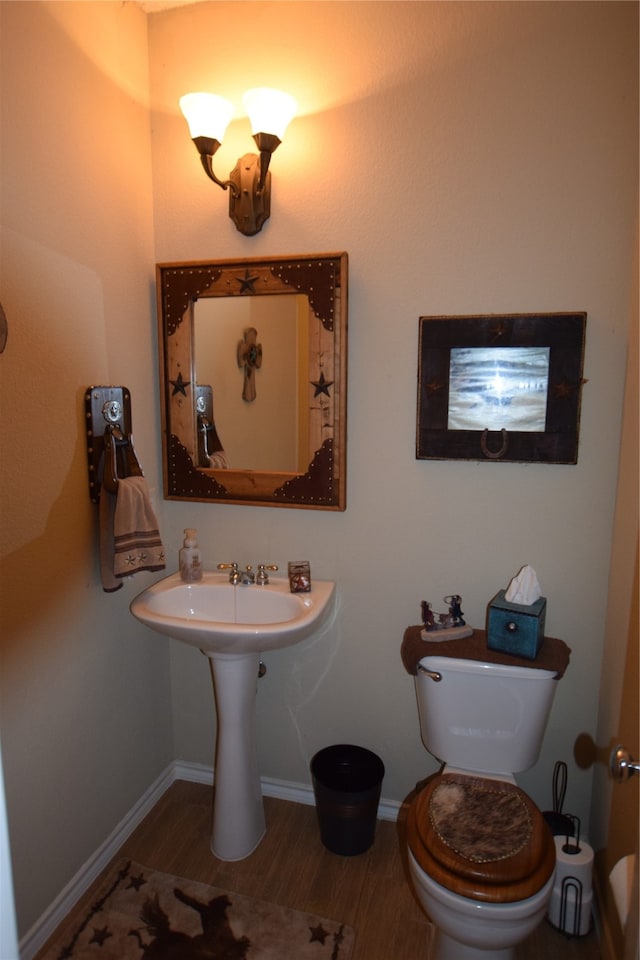 bathroom with wood-type flooring and toilet