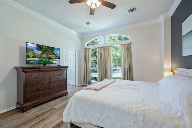 bedroom with ceiling fan, crown molding, and light hardwood / wood-style floors