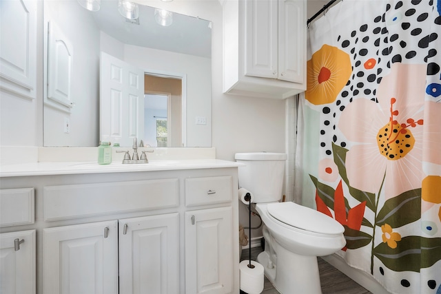 bathroom featuring a shower with shower curtain, vanity, wood-type flooring, and toilet