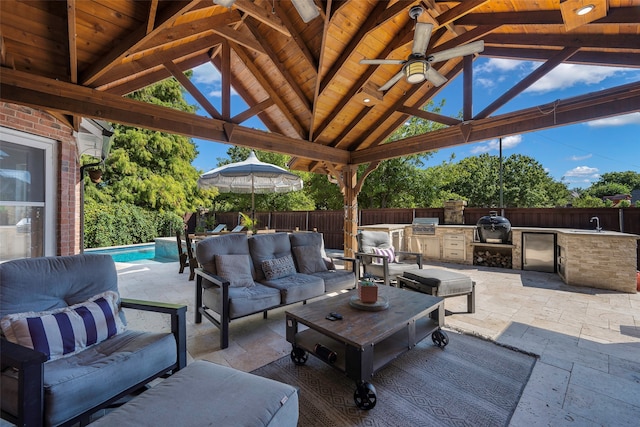 view of patio featuring a gazebo, area for grilling, an outdoor living space, and a fenced in pool