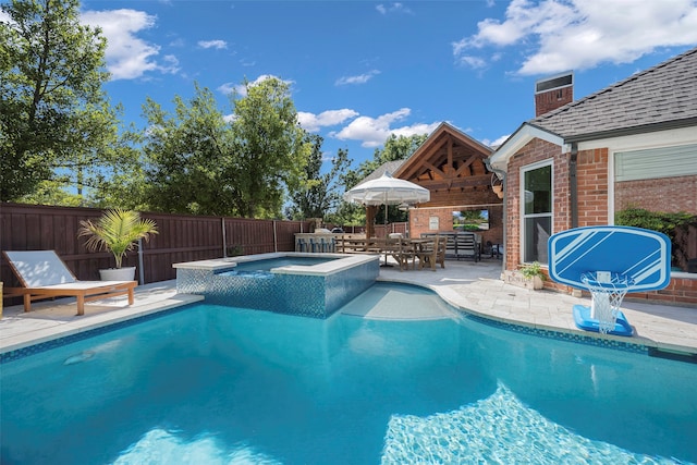 view of pool featuring an in ground hot tub and a patio