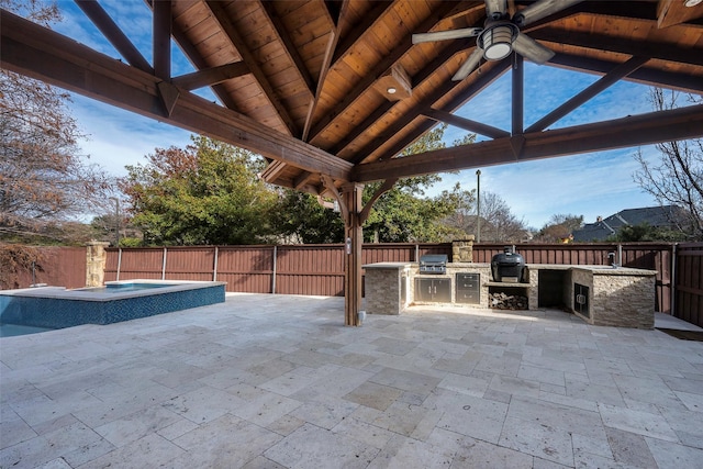 view of patio with a gazebo, grilling area, ceiling fan, and exterior kitchen