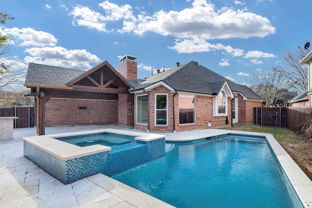 view of swimming pool with an in ground hot tub and a patio area