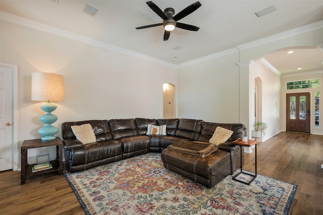 living room with dark hardwood / wood-style floors, ornate columns, ceiling fan, and crown molding