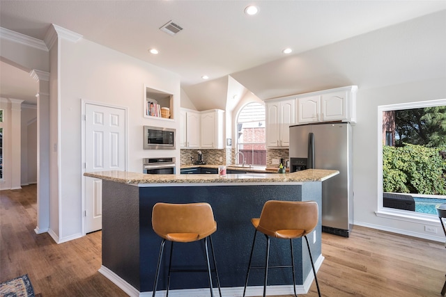 kitchen with white cabinetry, sink, an island with sink, and appliances with stainless steel finishes