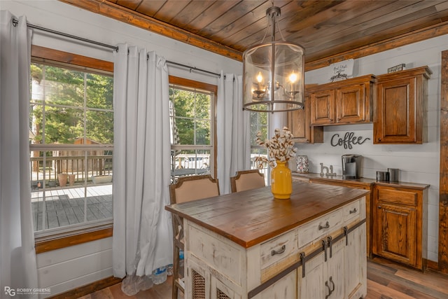 kitchen with wood ceiling, wood walls, an inviting chandelier, light hardwood / wood-style flooring, and decorative light fixtures