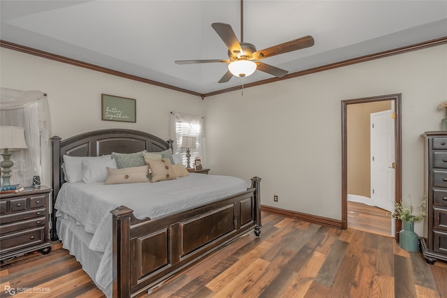 bedroom with ornamental molding, dark hardwood / wood-style flooring, and ceiling fan