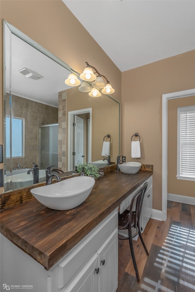 bathroom featuring a shower with door, vanity, and hardwood / wood-style flooring