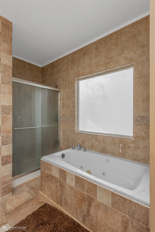 bathroom featuring ornamental molding, tile walls, and separate shower and tub