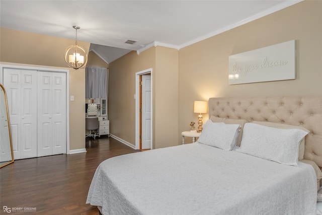 bedroom featuring a chandelier, a closet, dark wood-type flooring, vaulted ceiling, and crown molding