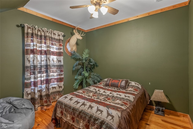 bedroom featuring wood-type flooring and ceiling fan