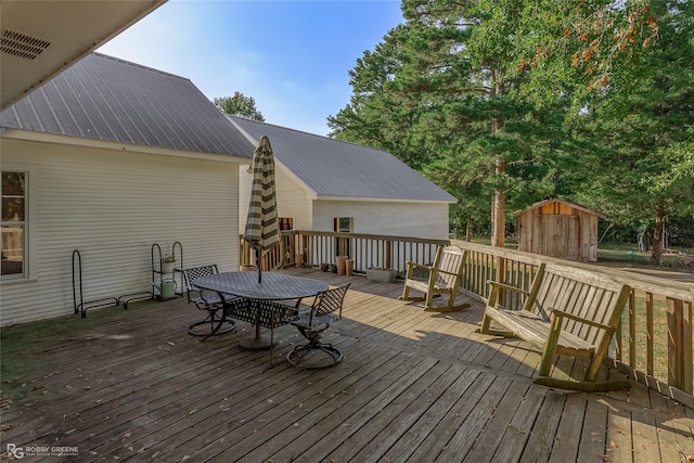 9321 Mccain Rd, Shreveport, LA 71107 - wooden terrace with an outbuilding, a shed, and outdoor dining area