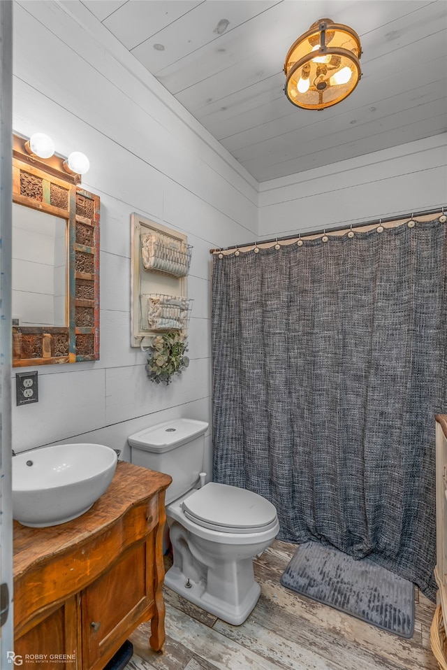 bathroom with toilet, vanity, hardwood / wood-style floors, and a shower with shower curtain