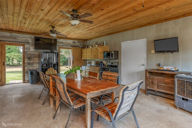 dining space with ceiling fan, heating unit, wood ceiling, and wooden walls