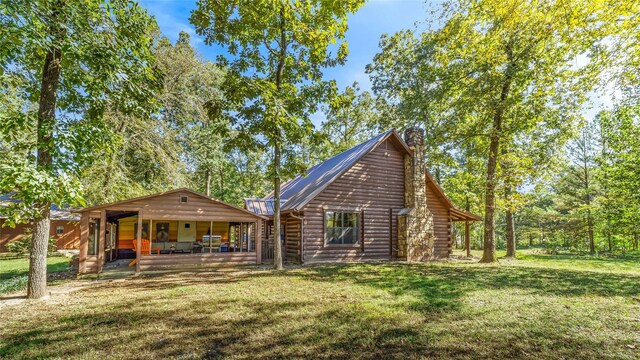 rear view of property with a lawn