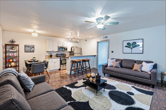 4633 Fairmount St Unit 202, Dallas, TX 75219 - living area featuring a ceiling fan, baseboards, and wood finished floors