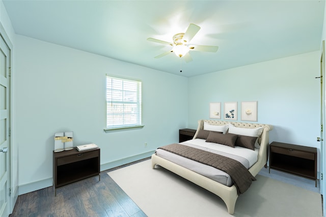 bedroom featuring ceiling fan and dark wood-type flooring