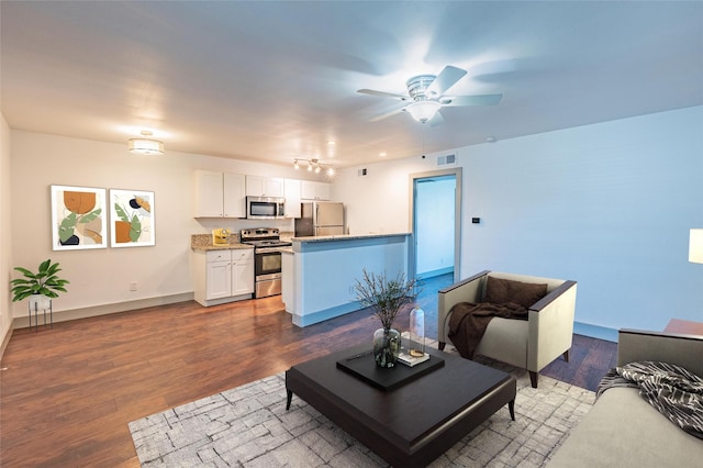 living room featuring dark hardwood / wood-style floors and ceiling fan