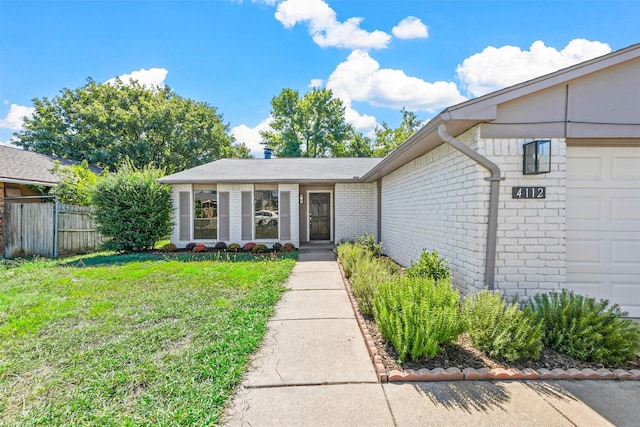 property entrance featuring a garage and a yard