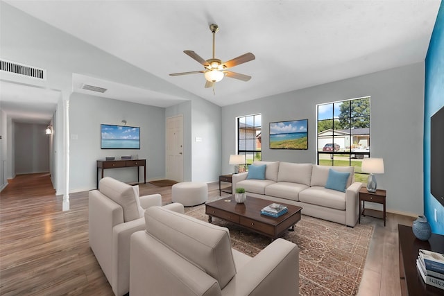 living room with lofted ceiling, light hardwood / wood-style floors, and ceiling fan