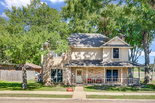 view of front of house featuring a front lawn and covered porch