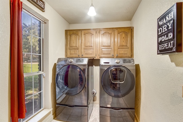 laundry area featuring cabinets and washing machine and clothes dryer