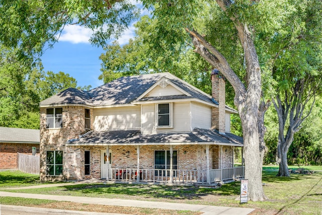 view of front of home featuring a front yard and covered porch