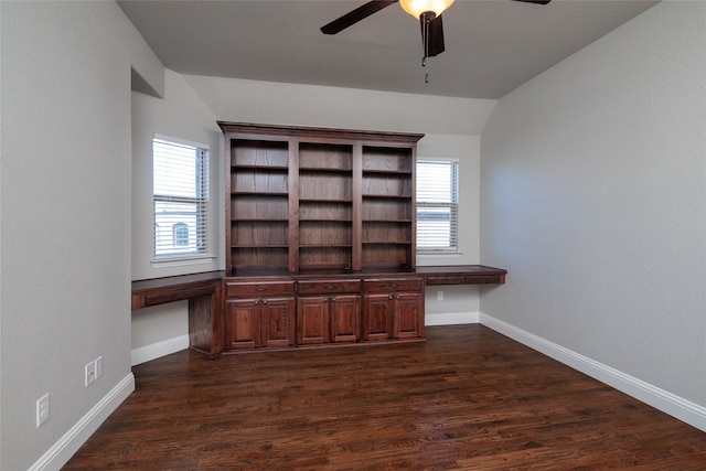 unfurnished office with vaulted ceiling, ceiling fan, a healthy amount of sunlight, and dark hardwood / wood-style flooring