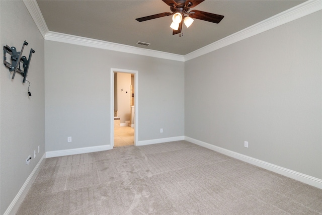 carpeted spare room with ceiling fan and crown molding