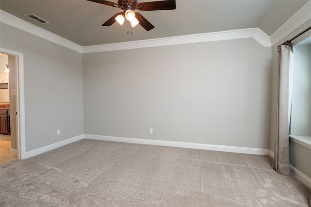 interior space with connected bathroom, ornamental molding, ceiling fan, and light colored carpet