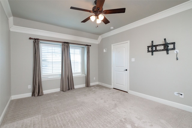 carpeted spare room with ornamental molding and ceiling fan