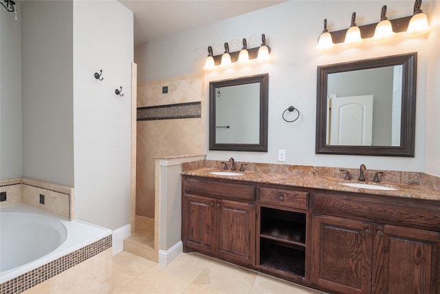 bathroom with tile patterned flooring, vanity, and separate shower and tub