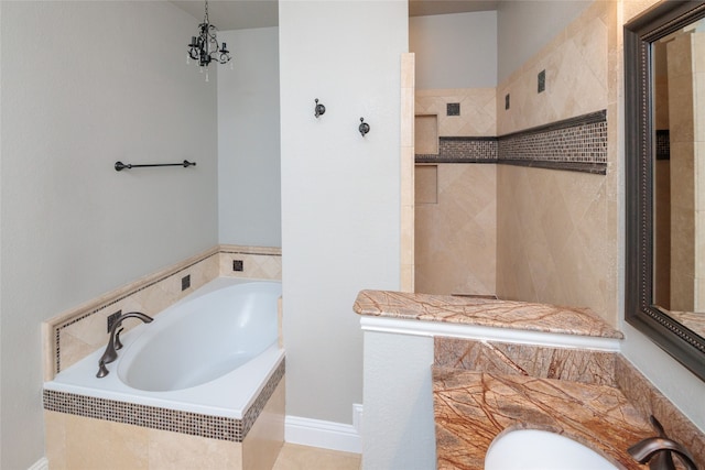 bathroom featuring tiled tub and tile patterned floors