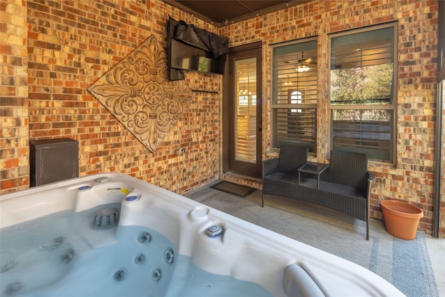 bathroom with brick wall and a bathtub