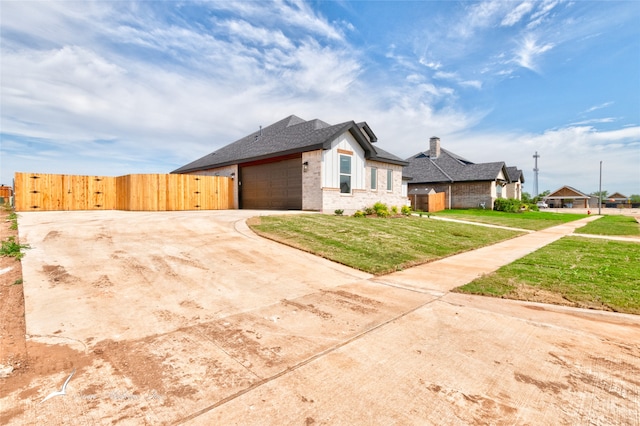 view of front of house featuring a garage and a front lawn