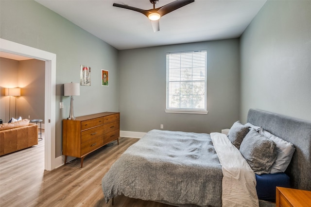 bedroom with ceiling fan and light hardwood / wood-style floors