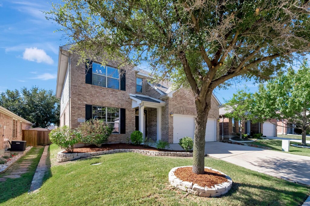 view of front of property featuring a front lawn and central air condition unit